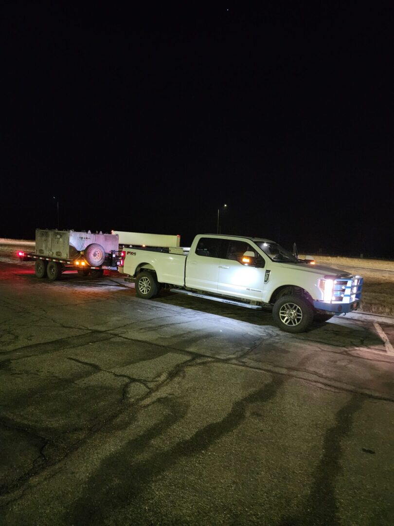 A car towing a trailer during the night